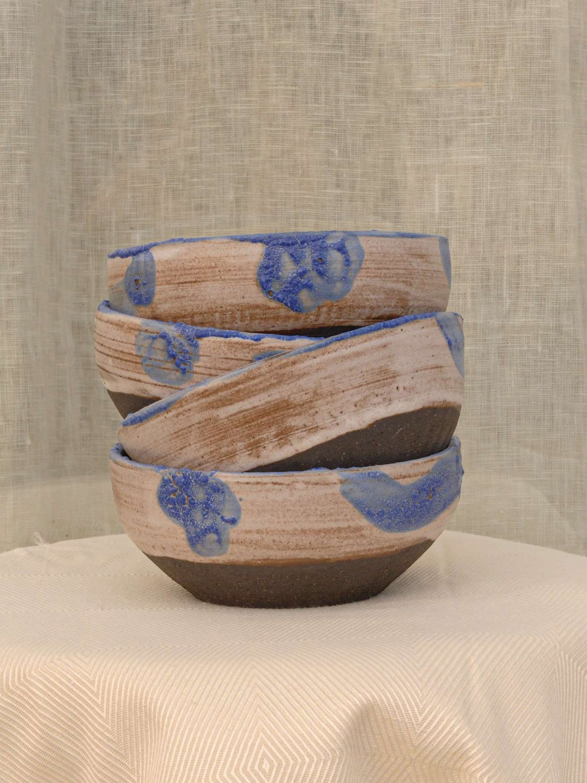 Set of two black clay bowls with textured crawling glaze