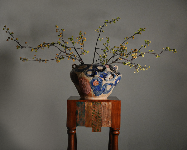 Tall coil-built stoneware vase decorated with sketches and Icelandic black sand