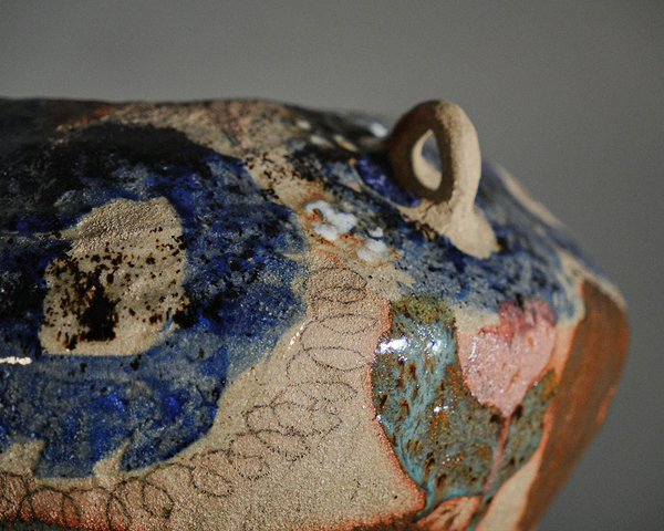 Tall coil-built stoneware vase decorated with sketches and Icelandic black sand