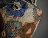 Tall coil-built stoneware vase decorated with sketches and Icelandic black sand