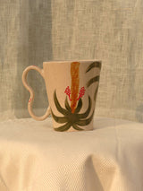 Wheel-thrown ceramic mug with wavy handle and Arabic calligraphy