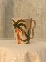 Wheel-thrown ceramic mug with wavy handle and Arabic calligraphy