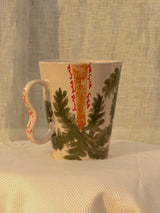 Wheel-thrown ceramic mug with wavy handle and the Arabic word for love