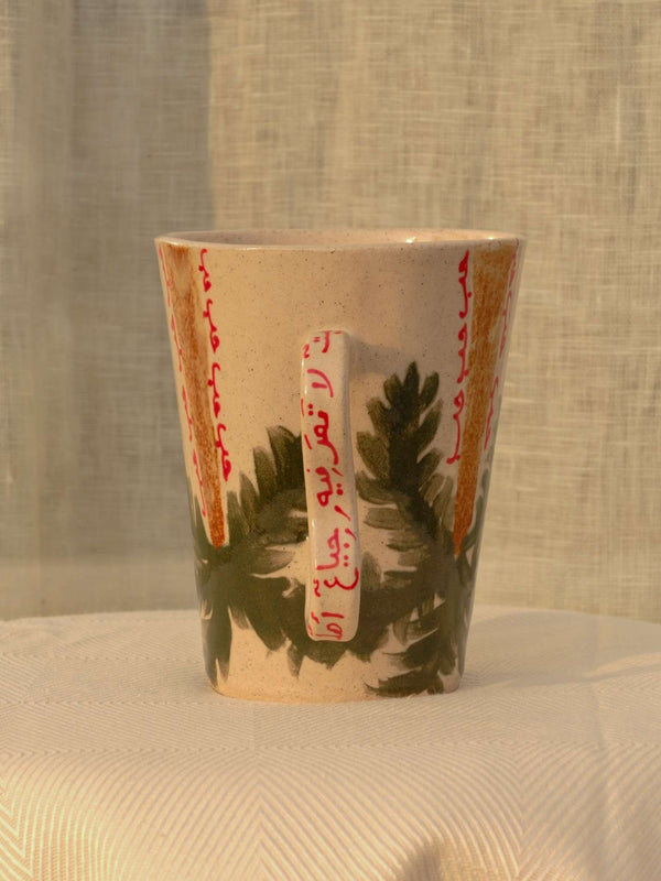 Wheel-thrown ceramic mug with wavy handle and Arabic calligraphy