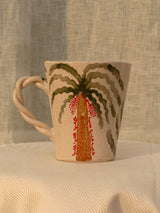 Wheel-thrown ceramic mug with wavy handle and the Arabic word for love