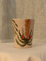 Wheel-thrown ceramic mug with wavy handle and the Arabic word for love