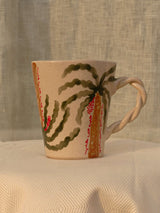 Wheel-thrown ceramic mug with wavy handle and the Arabic word for love