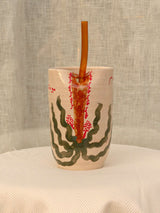 Wheel-thrown ceramic tumbler with palm trees and Arabic calligraphy