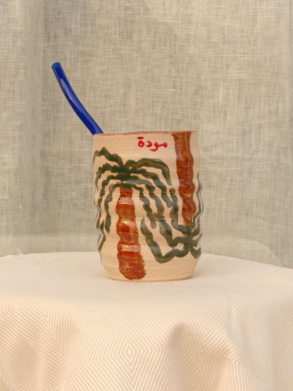 Wheel-thrown swirl ceramic tumbler with palm trees and Arabic calligraphy