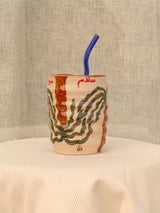 Wheel-thrown swirl ceramic tumbler with palm trees and Arabic calligraphy