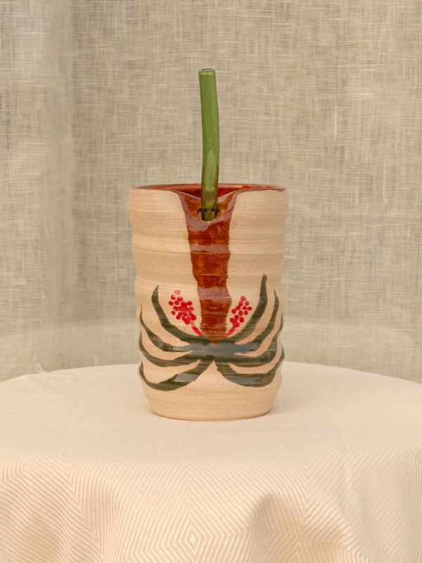Wheel-thrown swirl ceramic tumbler with palm trees and a glass straw