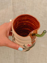 Wheel-thrown swirl ceramic tumbler with palm trees and a glass straw