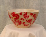 Large wheel-thrown salad bowl with red glaze strokes and undulated rim